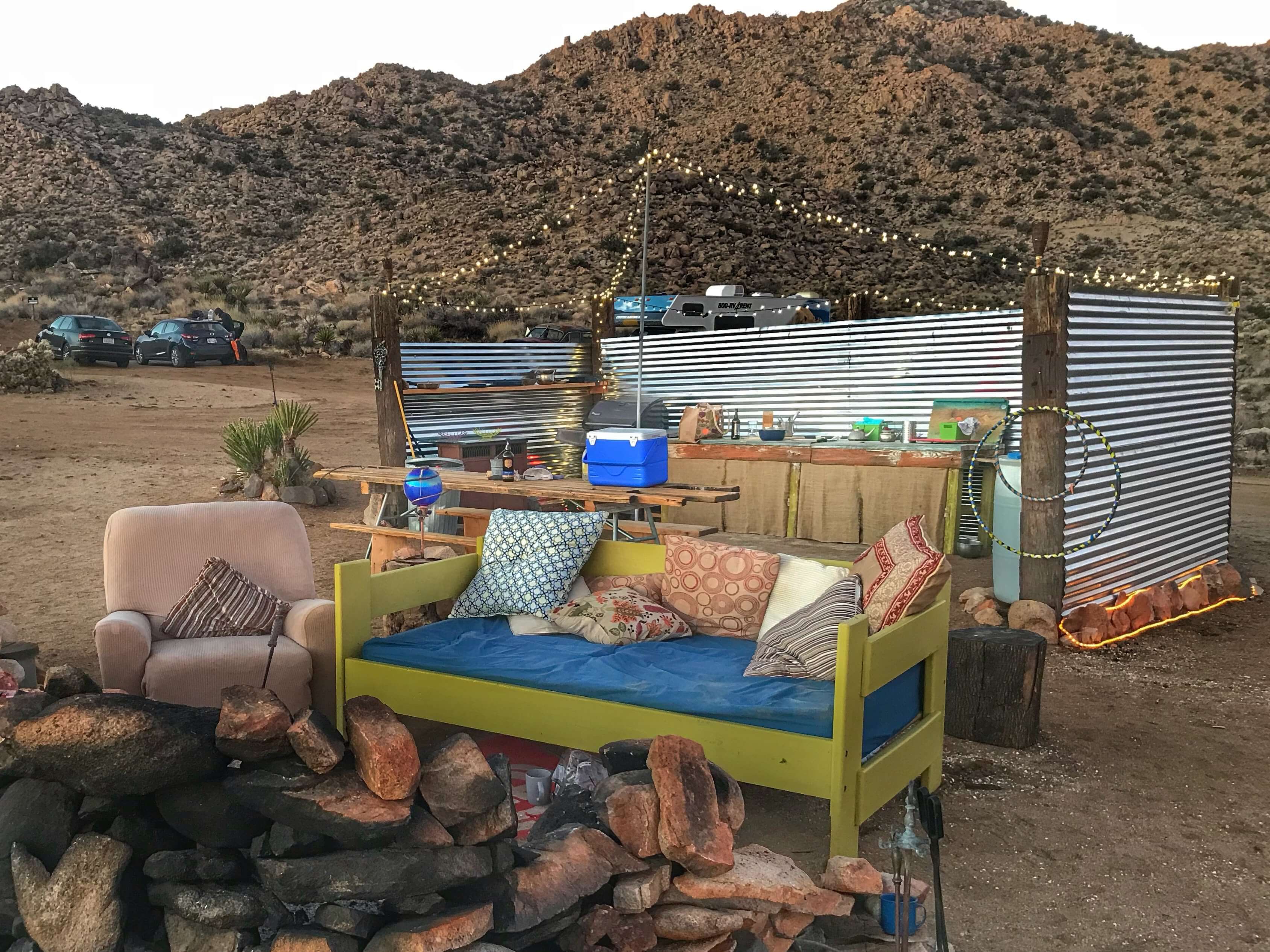 Kitchen and seating area near a communal firepit at private campground.