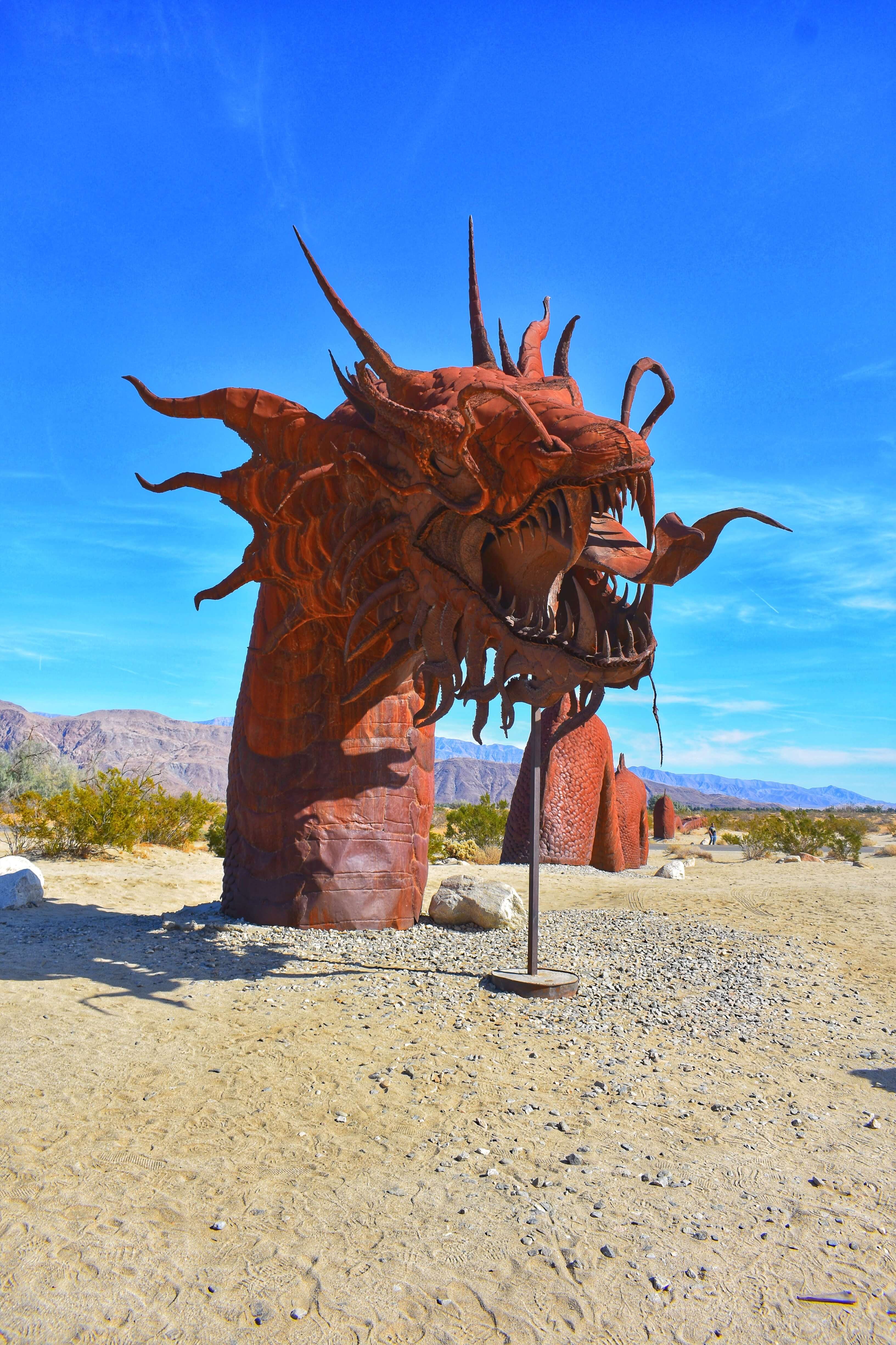 Dragon head sculpture coming up from the desert ground