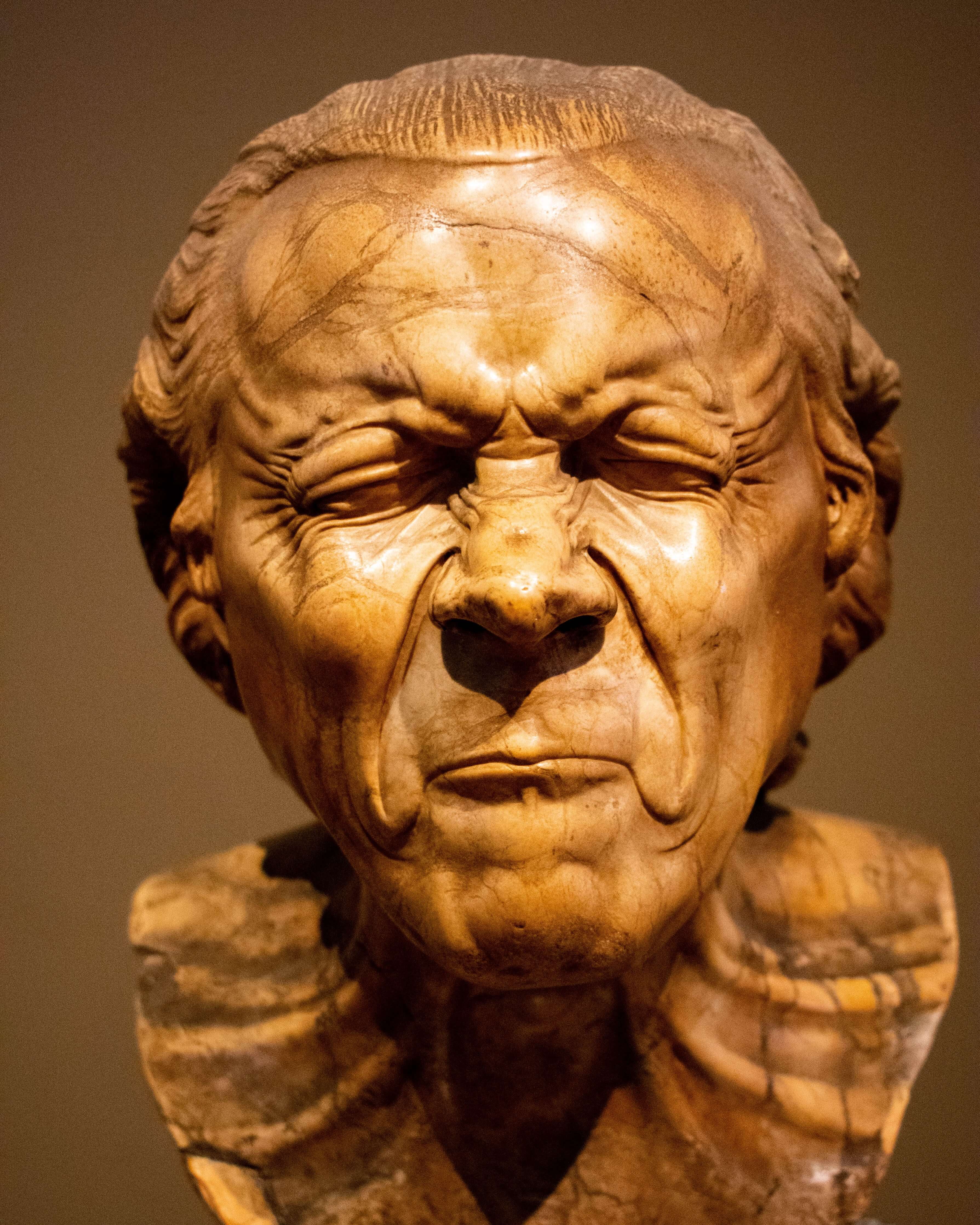 a sculpture of an old man who is vexed