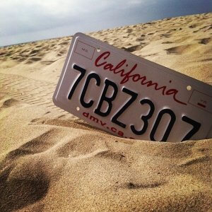 California license plate stuck in the sand