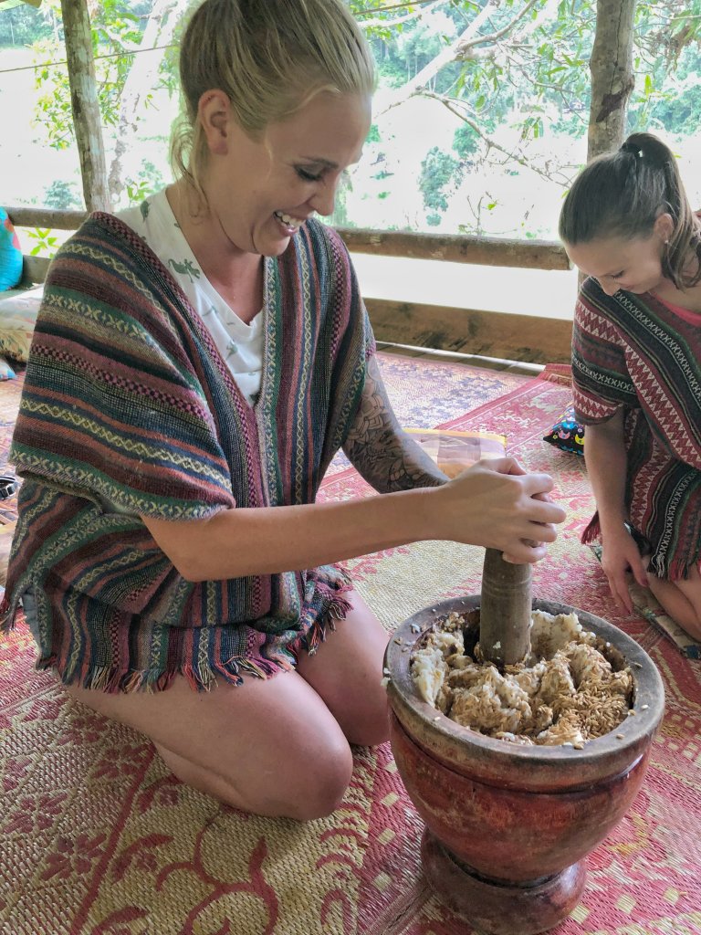 Me making medicine for the elephants with a huge bowl and dowel